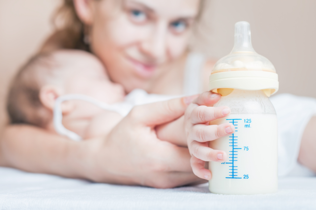 Mom Holding Baby Hand Holding Baby Bottle